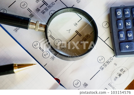 A magnifying glass and a pen over an isometric diagram A magnifying glass and a pen over an isometric diagram 103154576