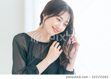 Young woman doing skin care in the living room Young woman doing skin care in the living room 103155083