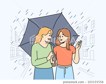 Smiling girls walking under umbrella on street  103155556