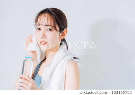 Young woman in sportswear wiping sweat Young woman in sportswear wiping sweat 103155793