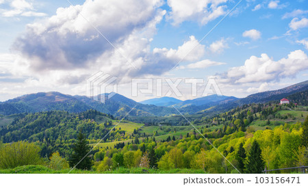 sunset over the rural mountain valley. the rolling hills and mountain peaks provide a stunning backdrop sunset over the rural mountain valley. the rolling hills and mountain peaks provide a stunning backdrop 103156471