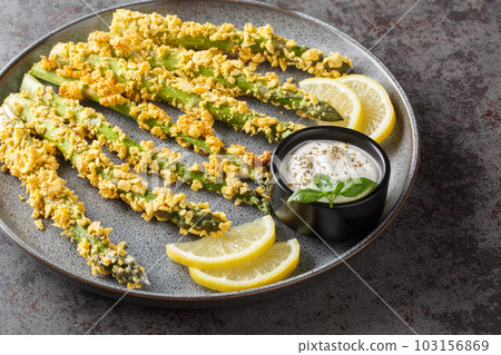 Keto Baked Parmesan Asparagus Fries with panko close-up on a plate. Horizontal 103156869