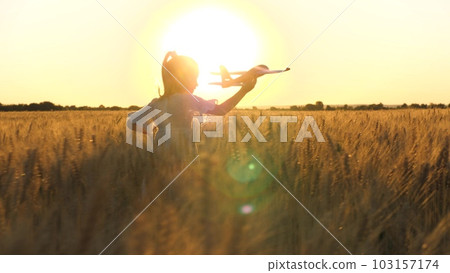 little child girl daughter runs through wheat field with toy plane her hand sunset, happy family dream fly, kid child with airplane, holiday child runs with toy plane across field rays sunset summer little child girl daughter runs through wheat field with toy plane her hand sunset, happy family dream fly, kid child with airplane, holiday child runs with toy plane across field rays sunset summer 103157174