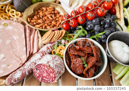 Fresh bread, pastries. Table full of mediterranean appetizers, tapas or antipasto. Assorted Italian food set. Delicious snack on party or picnic time. Italian style banquet.  103157245