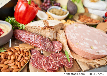 Fresh bread, pastries. Table full of mediterranean appetizers, tapas or antipasto. Assorted Italian food set. Delicious snack on party or picnic time. Italian style banquet. Fresh bread, pastries. Table full of mediterranean appetizers, tapas or antipasto. Assorted Italian food set. Delicious snack on party or picnic time. Italian style banquet. 103157252