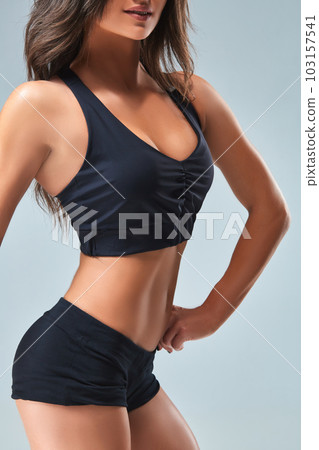 Slim woman's body over grey background Slim woman's body over grey background 103157541