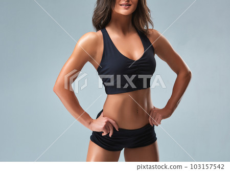 Slim woman's body over grey background 103157542