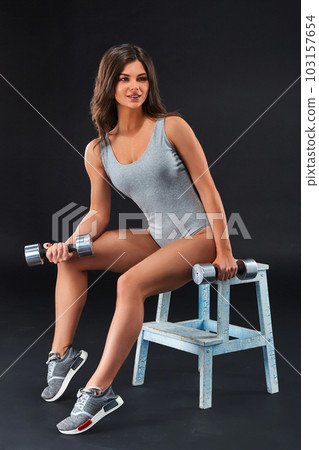 Perfect fitness body of beautiful woman. -instructor in sports clothing on black background. 103157654