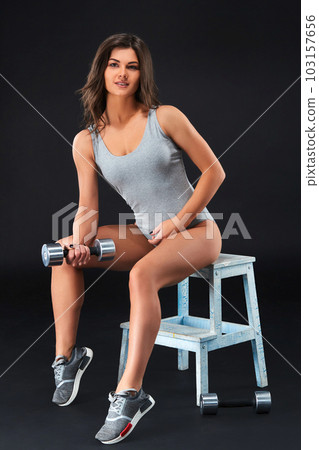Perfect fitness body of beautiful woman. -instructor in sports clothing on black background. 103157656