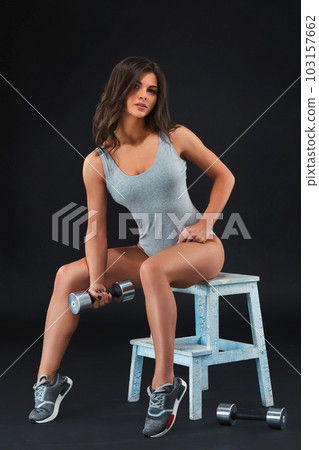 Perfect fitness body of beautiful woman. -instructor in sports clothing on black background. 103157662