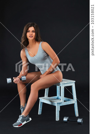 Perfect fitness body of beautiful woman. -instructor in sports clothing on black background. 103158021