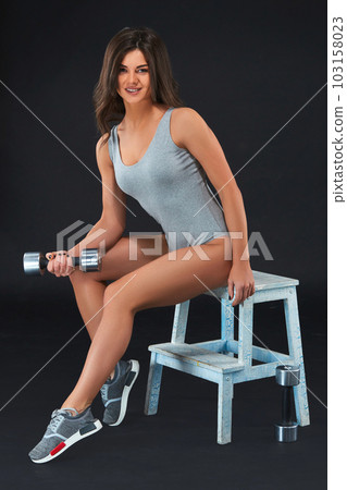 Perfect fitness body of beautiful woman. -instructor in sports clothing on black background. 103158023