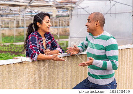 Latin american farmers discuss current topics during a working break. Latin american farmers discuss current topics during a working break. 103158499