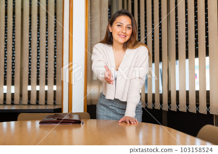Positive businesswoman with briefcase for documents in office 103158524