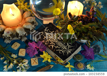 Tarot cards, candles, runes and magic ball on ritual altar table. Occult, esoteric and divination still life. Mystic background with vintage objects Tarot cards, candles, runes and magic ball on ritual altar table. Occult, esoteric and divination still life. Mystic background with vintage objects 103158559