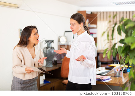 Unhappy woman chief screaming to young female manager Unhappy woman chief screaming to young female manager 103158705