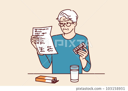 Elderly man takes medicine and reads dosage instructions for pills prescribed by doctor. 103158931