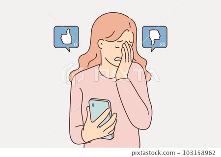 Woman blogger suffers sees dislikes under own post on social network and cries holding phone 103158962