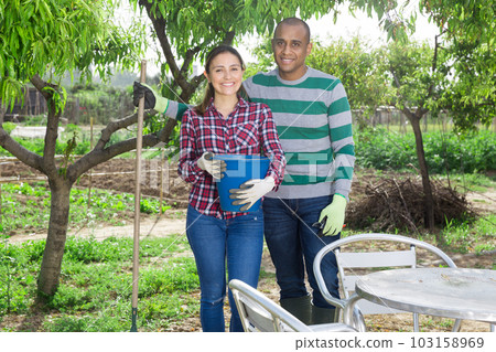 Portrait of young family in the backyard Portrait of young family in the backyard 103158969