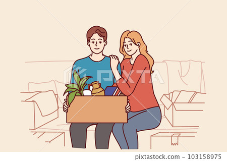 Happy couple is sitting on couch with cardboard box after moving or buying own apartment 103158975