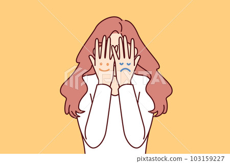 Faces with different moods are depicted on hands of woman hiding face for concept bipolar disorder Faces with different moods are depicted on hands of woman hiding face for concept bipolar disorder 103159227