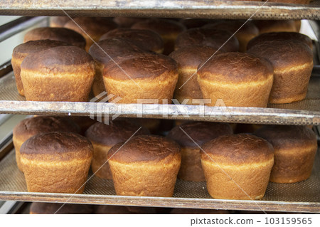 Industrial production of bread. Lots of baked goods on pallets. Freshly baked bun. Bakery 103159565