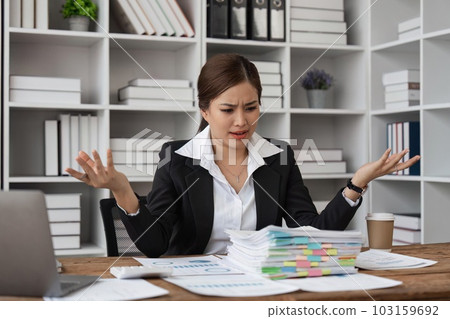 tired business woman sleepy and bored from sitting at a desk for a long time and has office syndrome tired business woman sleepy and bored from sitting at a desk for a long time and has office syndrome 103159692