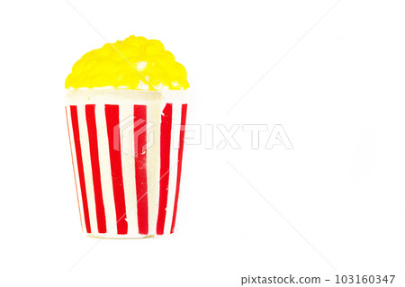 Toy bright striped glass with yellow popcorn. American culture concept.Popcorn in a red-white box Toy bright striped glass with yellow popcorn. American culture concept.Popcorn in a red-white box 103160347