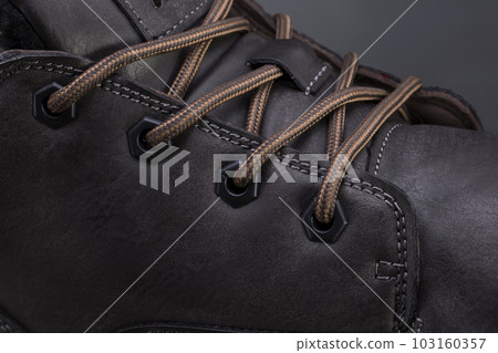 Part of a leather boot close-up. A fragment of the texture of leather shoes. Part of a leather boot close-up. A fragment of the texture of leather shoes. 103160357