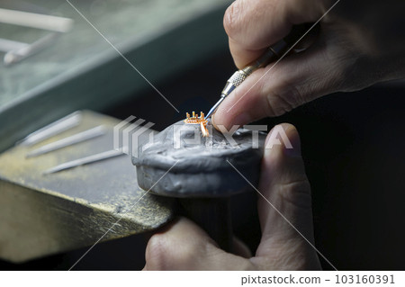 Hands make a golden decoration. Jewelry industry, Precious ring making. Hands make a golden decoration. Jewelry industry, Precious ring making. 103160391
