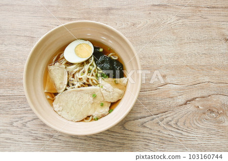 shoyu ramen or Japanese yellow noodles topping slice braised pork and boiled egg in soy sauce soup on bowl shoyu ramen or Japanese yellow noodles topping slice braised pork and boiled egg in soy sauce soup on bowl 103160744