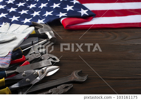 Tools and us flag on wooden background labor day banner mockup with copyspace Tools and us flag on wooden background labor day banner mockup with copyspace 103161175