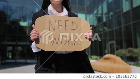 Close up woman holding poster cardboard with need job jobless message. Global unemployment. 103162776