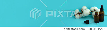 Banner. Glass bottles and cotton on a blue background. 103163553