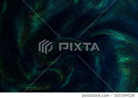 Gold Particles In Blue Fluid. Golden sparkling dust particles floating in a blue liquid with green tints, creating fantasy curved patterns and waves. Magic glittering galaxy. 103164526