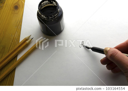 The woman writes with black ink. The woman writes with black ink. 103164554