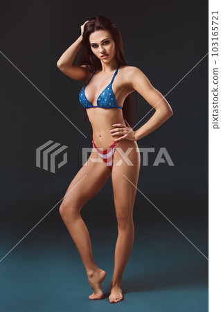 sexy young woman in erotic fetish wear dancing striptease in nightclub. Nude sexy woman in Show suit. sexy young woman in erotic fetish wear dancing striptease in nightclub. Nude sexy woman in Show suit. 103165721