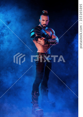 Handsome young sexy man with beautiful muscular chest in interesting costume on the scene Handsome young sexy man with beautiful muscular chest in interesting costume on the scene 103165895