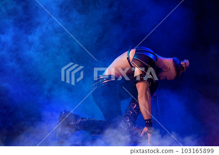 Handsome young sexy man with beautiful muscular chest in interesting costume on the scene 103165899