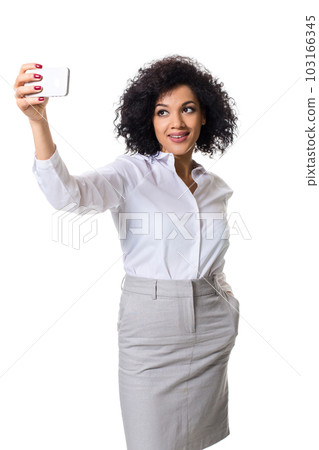 Beautiful brunette woman in classic white shirt and skirt make selfie on the phone. 103166345