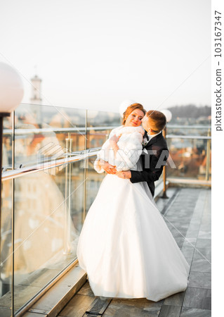 Romantic wedding moment, couple of newlyweds smiling portrait, bride and groom hugging 103167347