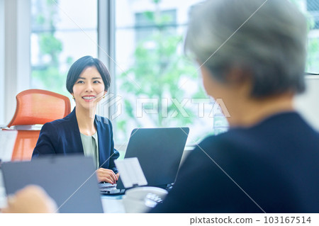 在辦公桌工作的西裝的女商人 在辦公桌工作的西裝的女商人 103167514