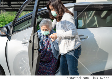 Caregiver help and support asian elderly woman sitting on wheelchair prepare get to her car to travel in holiday. Caregiver help and support asian elderly woman sitting on wheelchair prepare get to her car to travel in holiday. 103167536