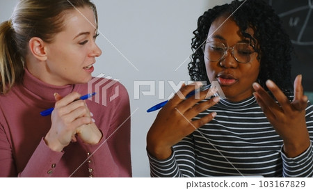 Confident pretty Indian employee talking to business colleague at shared workplace. Female mentor teaching intern, telling about work project. Manager and client discussing online product at laptop Confident pretty Indian employee talking to business colleague at shared workplace. Female mentor teaching intern, telling about work project. Manager and client discussing online product at laptop 103167829