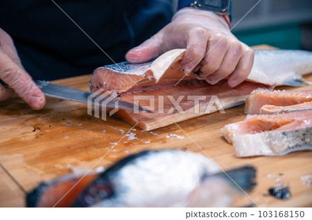 Chef preparing a salmon fish 103168150