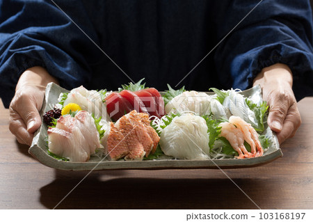 chef holding assorted sashimi, sashimi, japanese food, dining table, meal chef holding assorted sashimi, sashimi, japanese food, dining table, meal 103168197