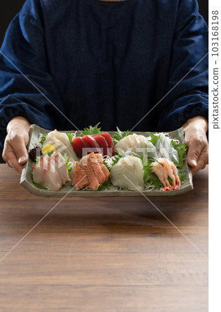 chef holding assorted sashimi, sashimi, japanese food, dining table, meal chef holding assorted sashimi, sashimi, japanese food, dining table, meal 103168198