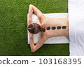 Woman lying on spa hot stone 103168395