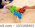 Business people assembling puzzle 103168403