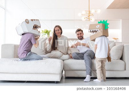 Family playing dinosaurs at home 103168406